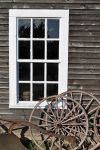An Old Plow and Wagon Wheels Lean Against a Barn in Steilacoom, Washington